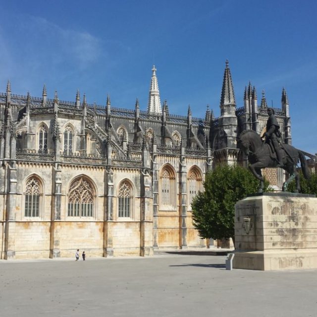 a large stone building with Batalha Monastery in the background