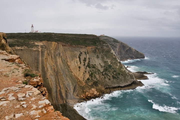 a rocky island in the middle of a body of water