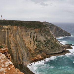 a rocky island in the middle of a body of water