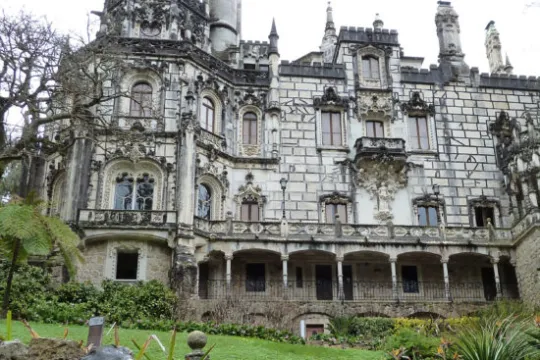 a large stone statue in front of a building