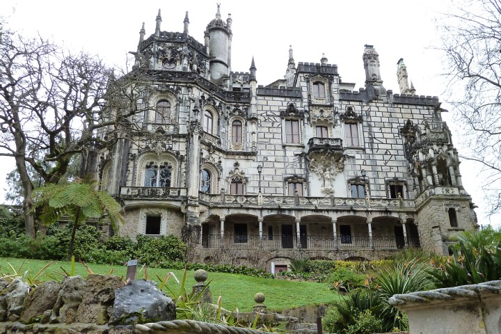a large stone statue in front of Quinta da Regaleira