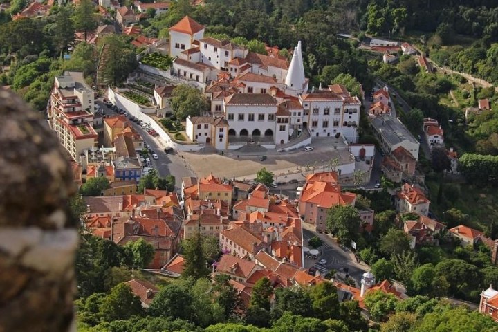 a large building with a mountain in the background