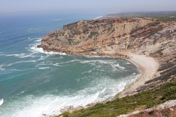 a body of water with a mountain in the ocean