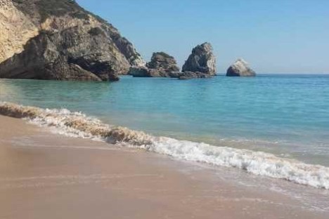 a rocky beach next to the ocean