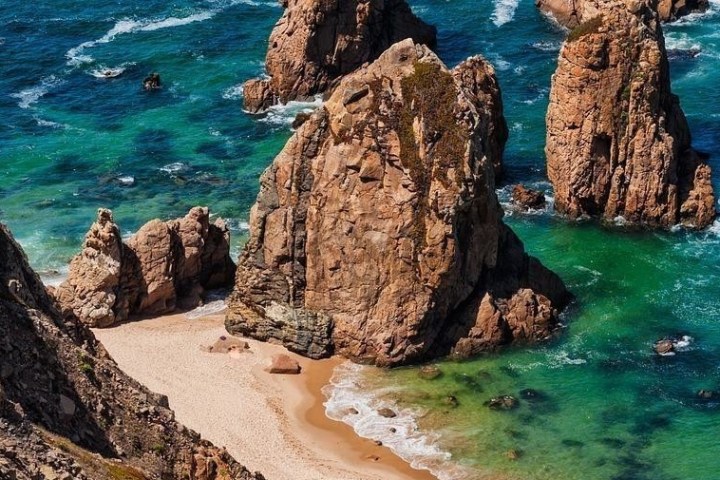 a close up of a rock near the ocean