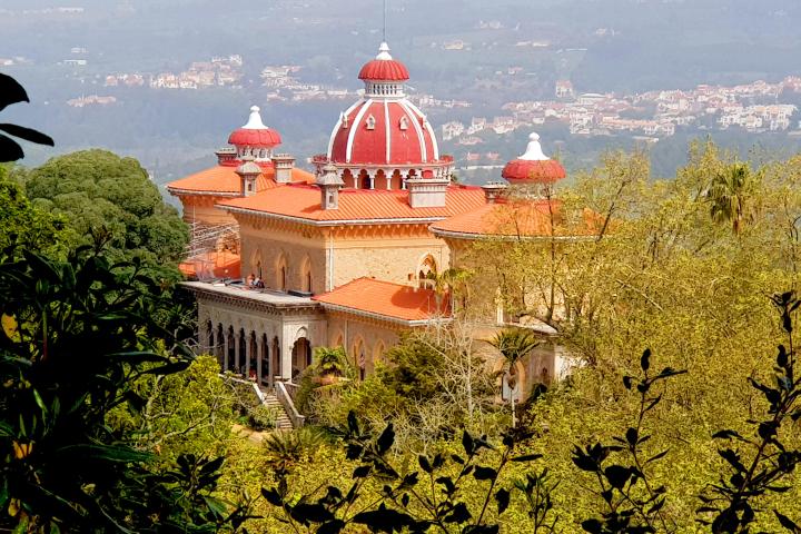 a large building with a mountain in the background
