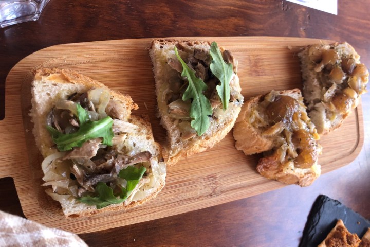 a sandwich sitting on top of a wooden cutting board