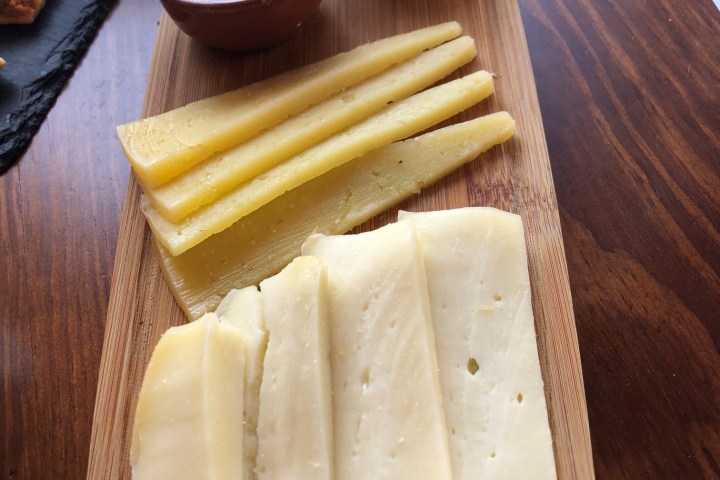 a slice of cake sitting on top of a wooden cutting board