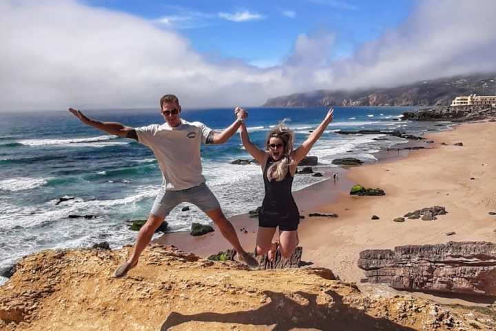 a person standing on top of a sandy beach