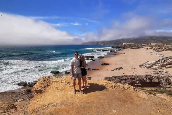a man standing on top of a sandy beach