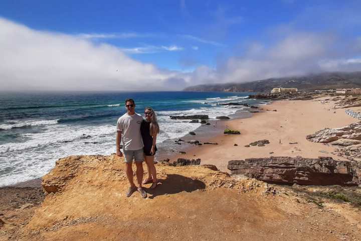 a man standing on top of a sandy beach