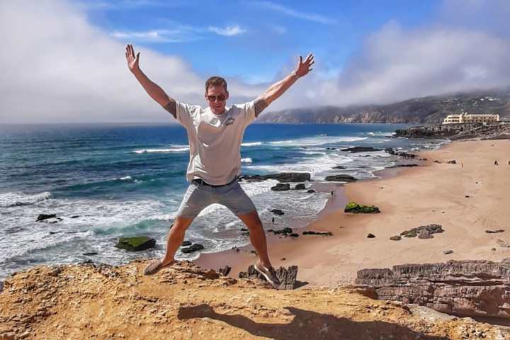 a person throwing a frisbee at the beach
