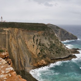 a rocky island in the middle of a body of water