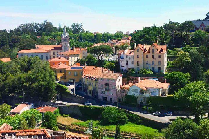 a castle on a train track with trees in the background