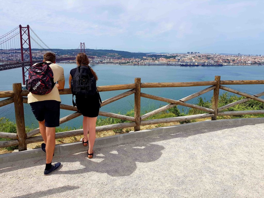 a woman standing next to a body of water