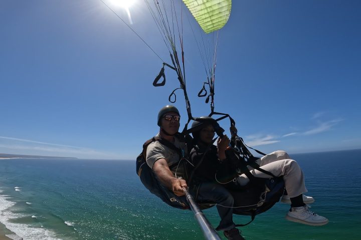 a man flying a kite in a body of water