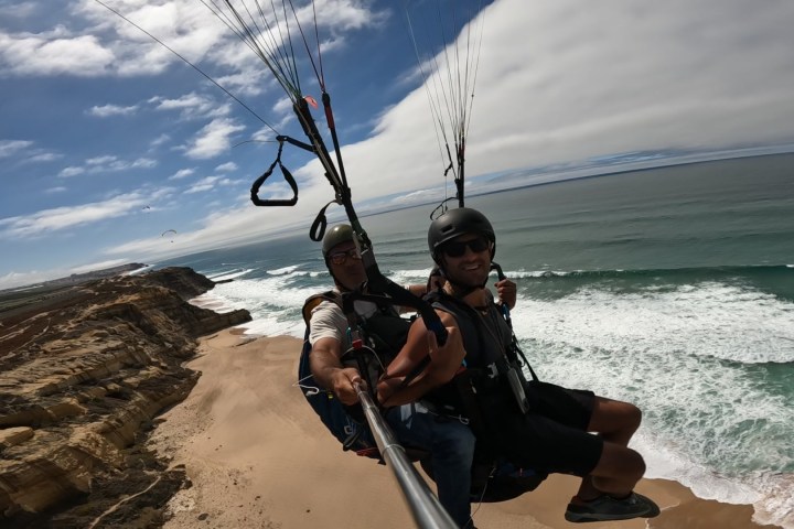a person sitting on top of a sandy beach