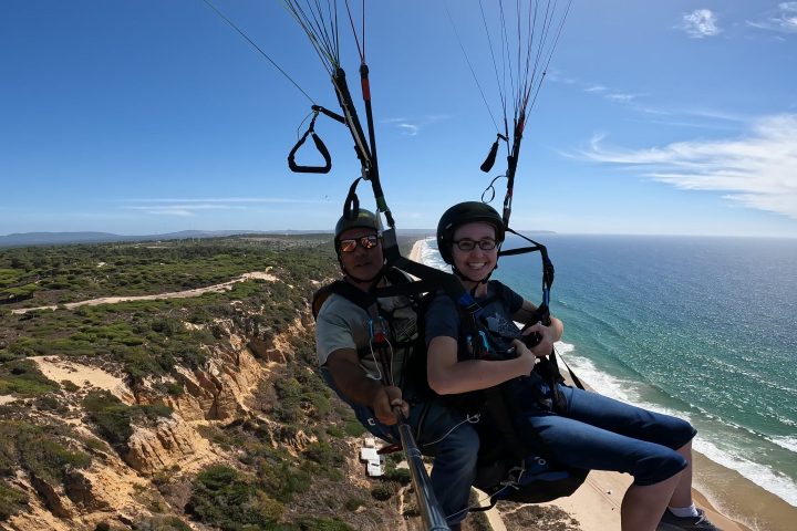 a person sitting next to a body of water