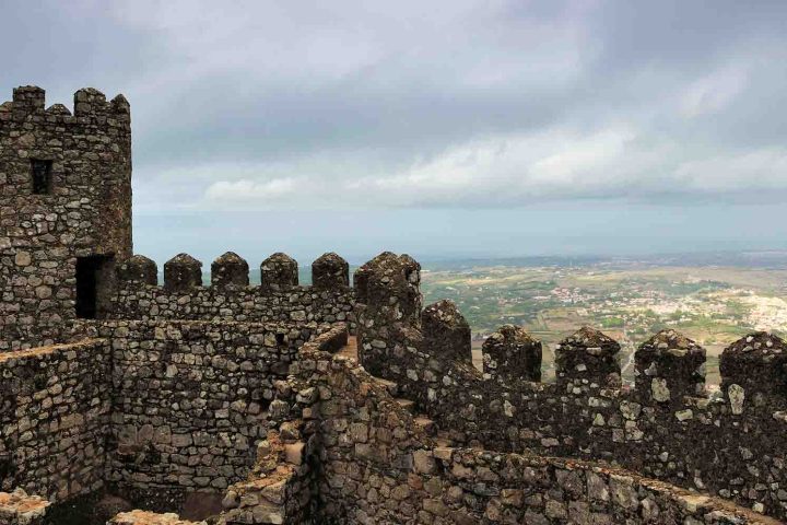 a castle on top of a rock wall