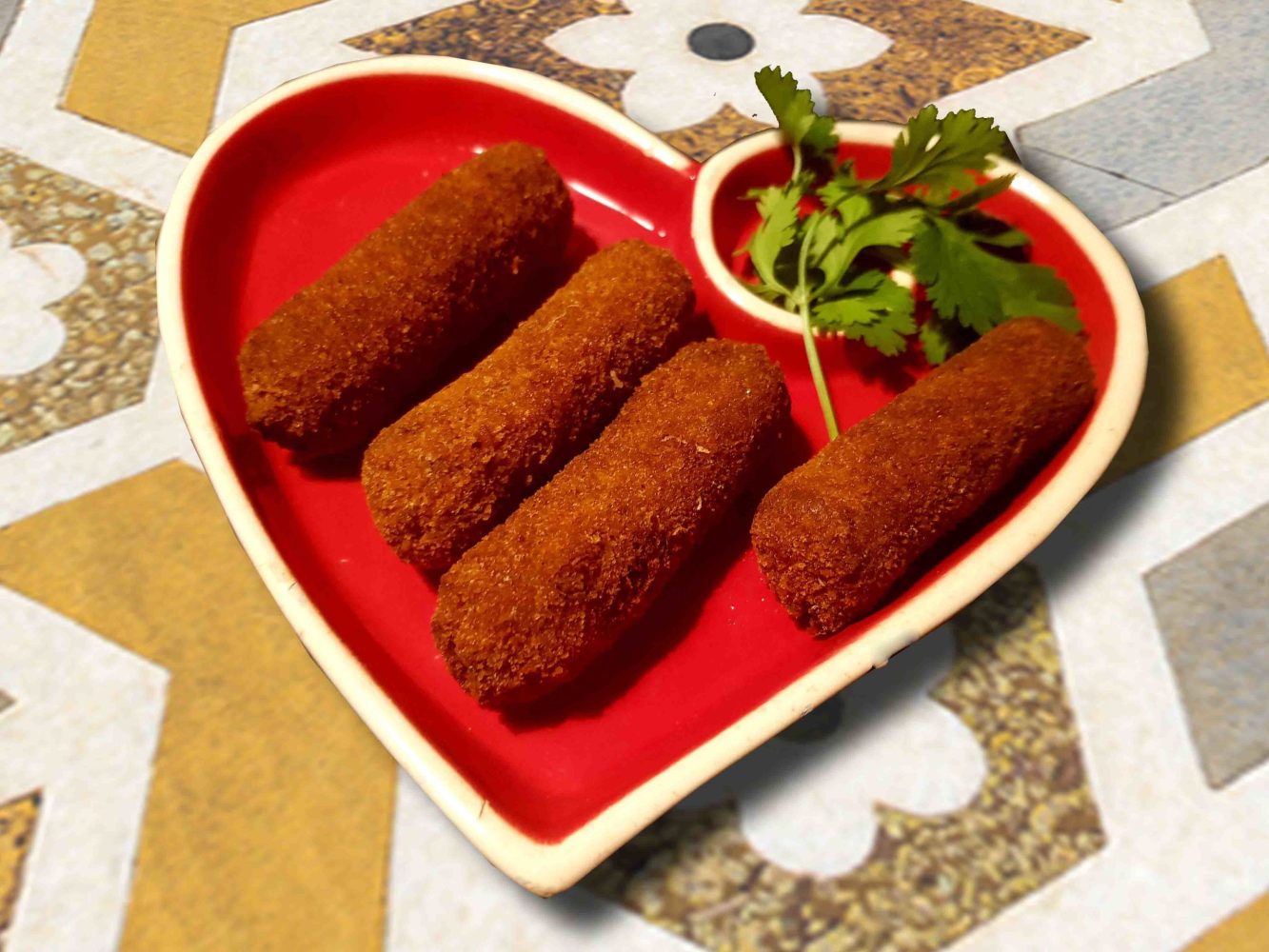 a red plate topped with different types of food on a table