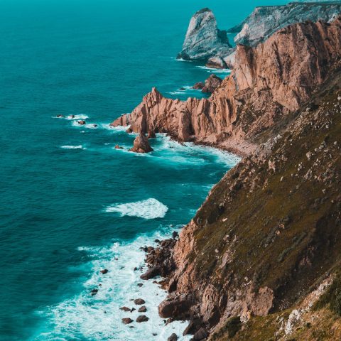a body of water with a mountain in the ocean