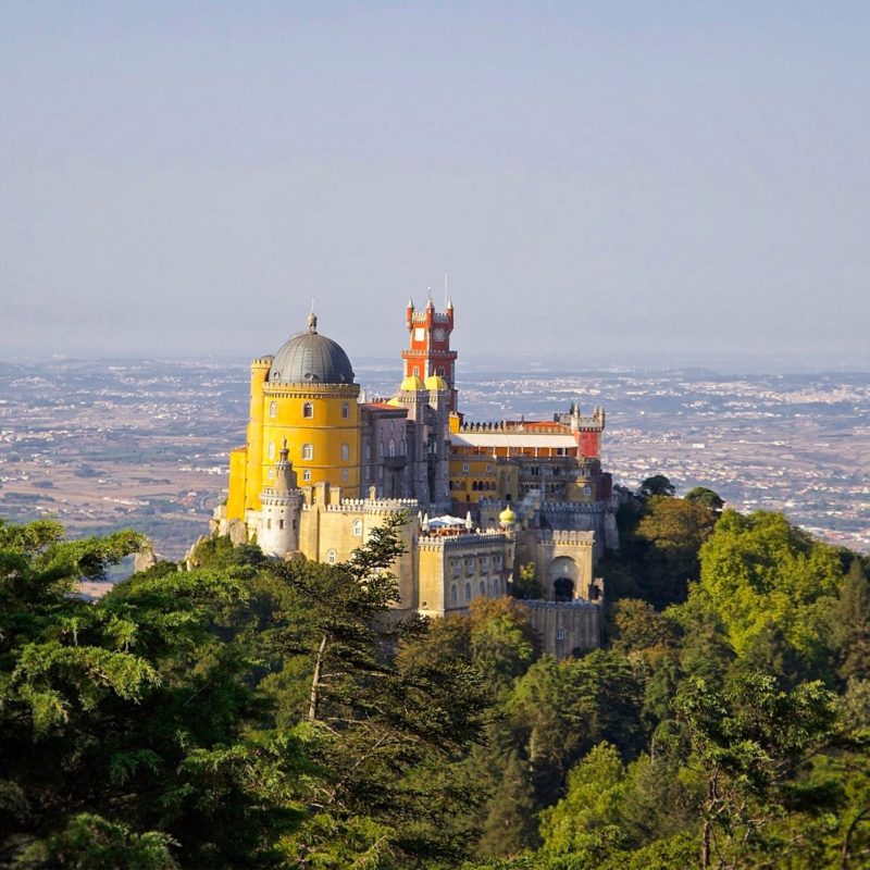 a castle with a mountain in the background