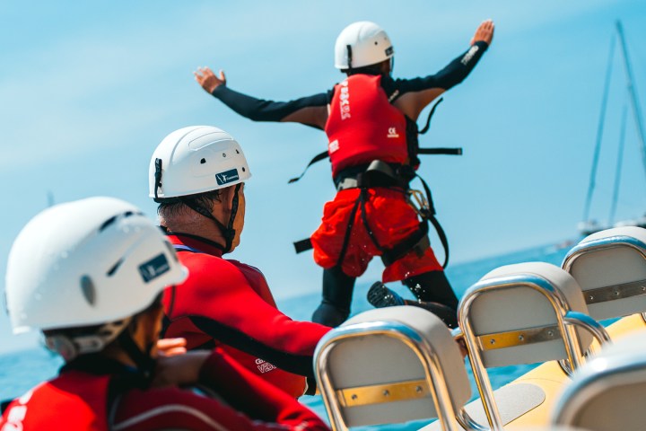 a group of people riding on the back of a motorcycle