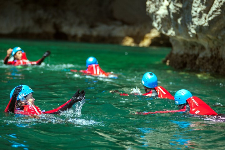 a group of people riding on the back of a boat