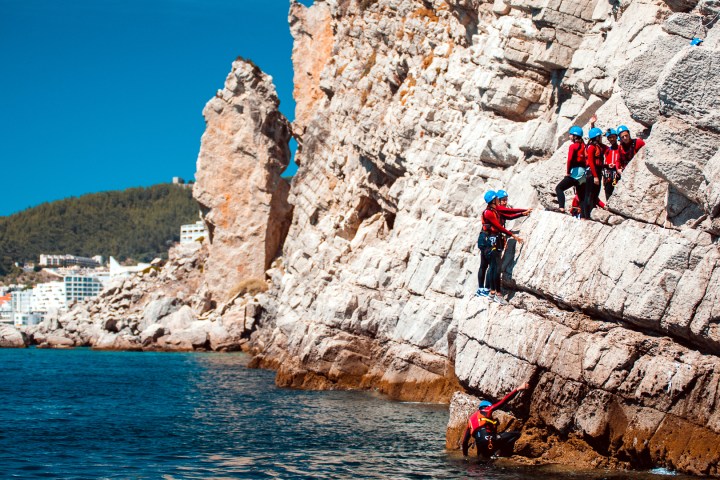 a group of people on a rock
