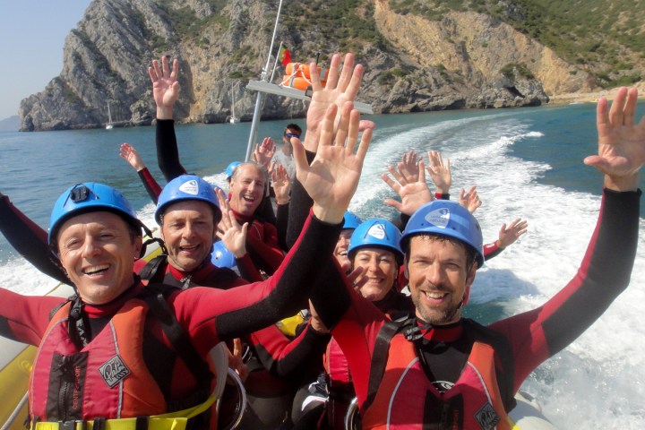 a group of people standing next to a body of water