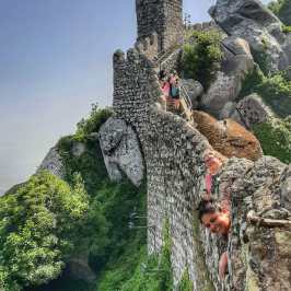 a person standing in front of a large rock