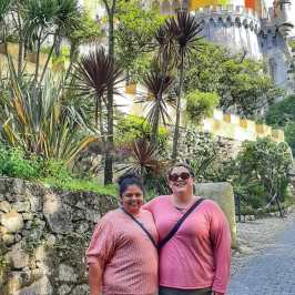 a person standing in front of a palm tree