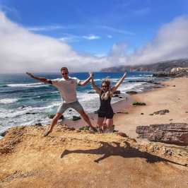 a person standing on top of a sandy beach