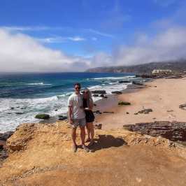 a man standing on top of a sandy beach