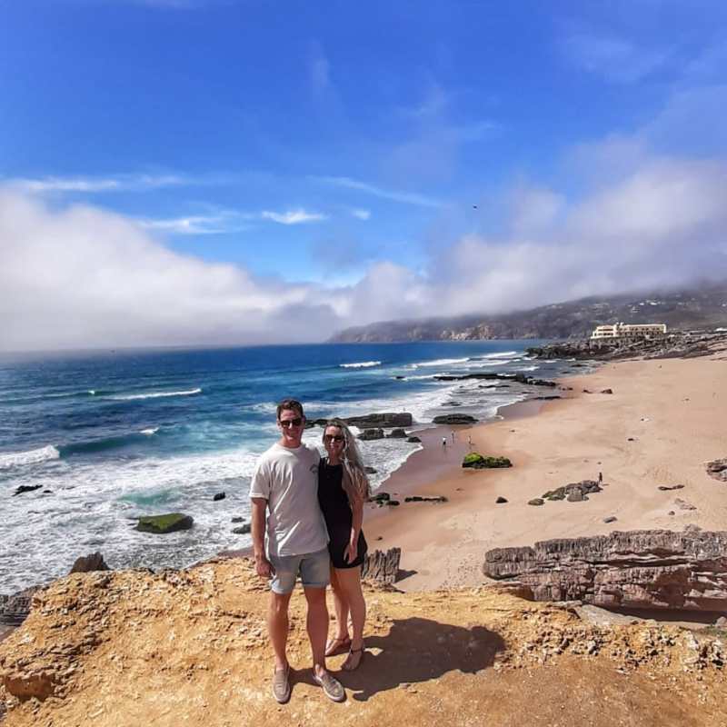 a man standing on top of a sandy beach