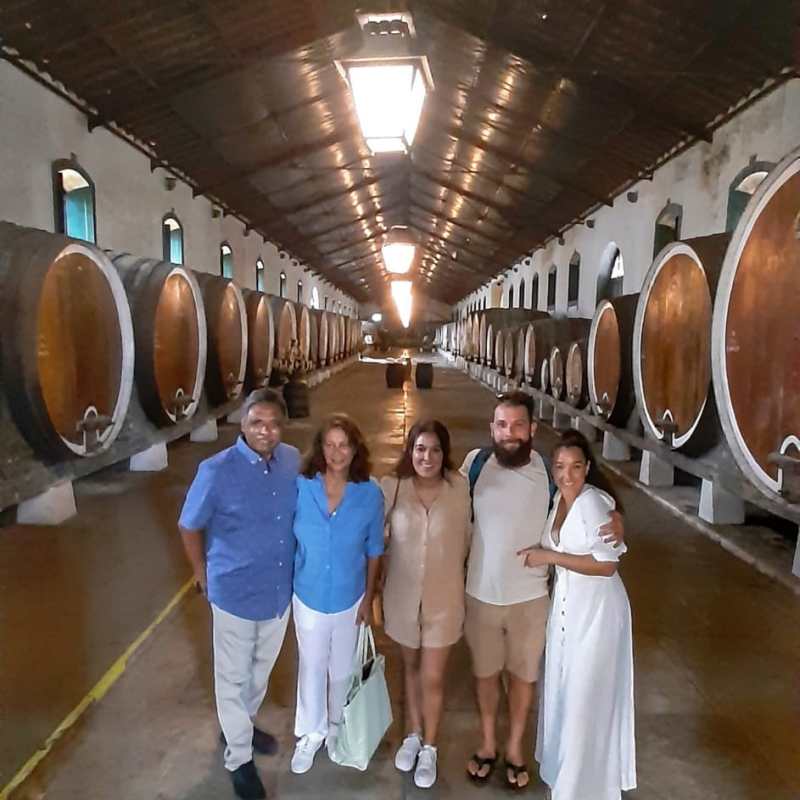 a group of people standing in front of a barrel