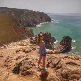 a man standing on a rocky beach