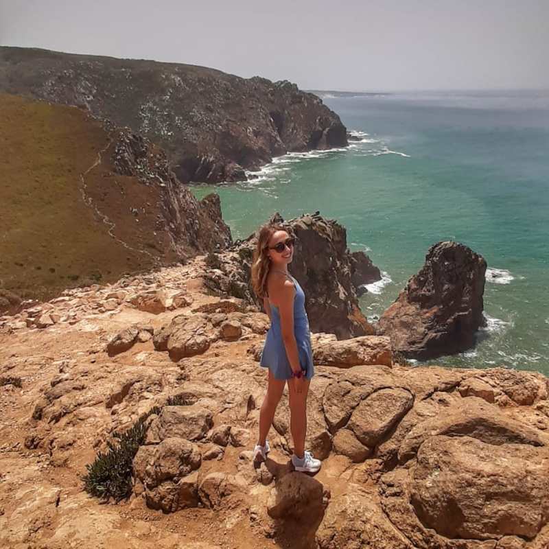a man standing on a rocky beach