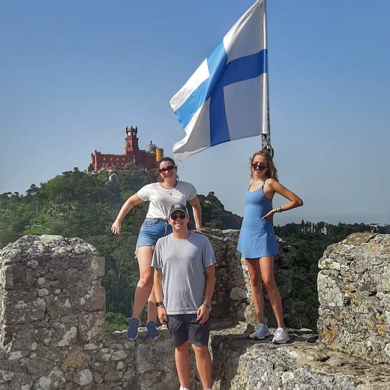 a man standing in front of a large rock