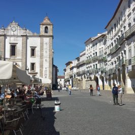a group of people walking in front of a building