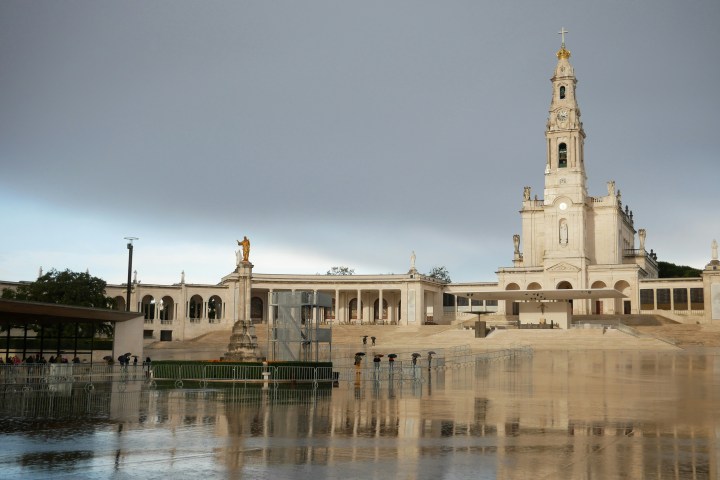 a castle with water in front of a building