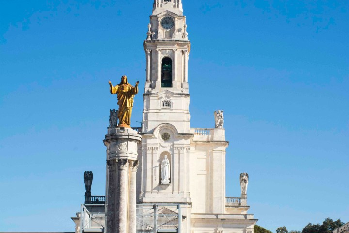 a group of people standing in front of a large building