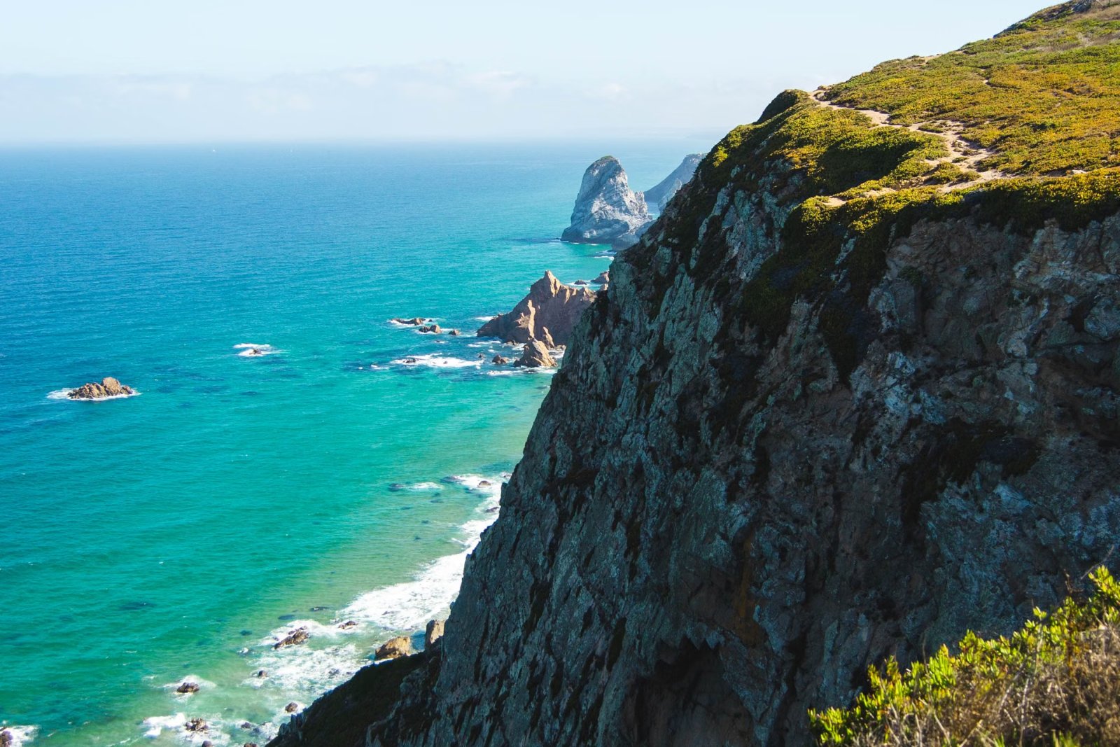 Cabo da Roca cliffs and the Atlantic Ocean under a clear sky on a day trip from Lisbon
